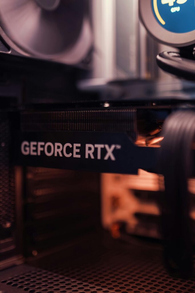 A detailed view of a GeForce RTX graphics card installed in a desktop computer setup.