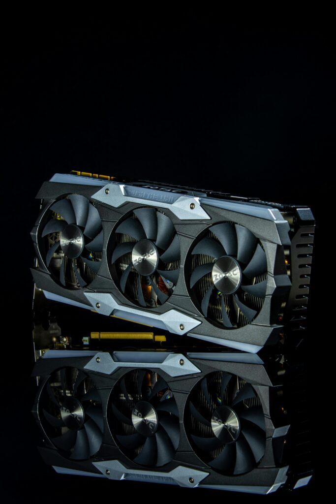 Close-up of a modern graphics card with three fans against a black background.